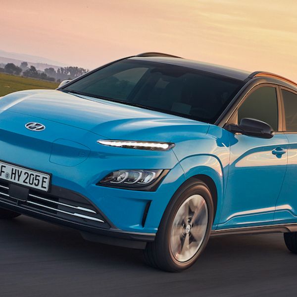 Hyundai Kona Electric car exterior front driving in country